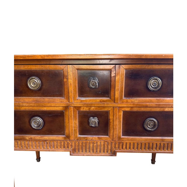 This is an Italian Neoclassical chest of drawers by Milling Road, a division of Baker Furniture. It is solid maple...