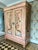 A striking antique French wardrobe, reworked with four hand-painted chinoiserie panels—swans, birds and florals—layered...