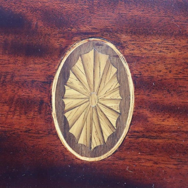 A matching pair of English knife boxes offer mahogany construction with sloped top having an inlaid satinwood patera and...