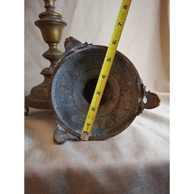 This is an exceptional and monumental pair of antique Eastern European brass Shabbat (Sabbath) candlesticks, standing at...