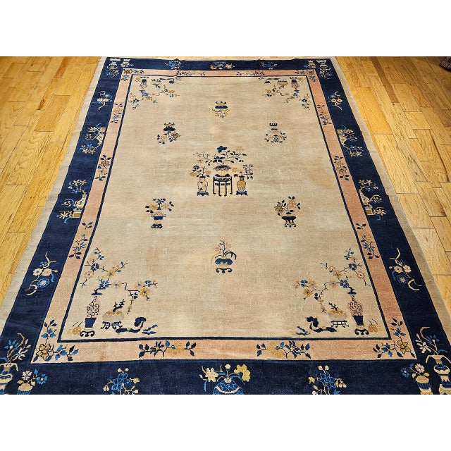 This elegant late 19th century Chinese Peking rug features a soft pale yellow field of great serenity, beautifully framed...
