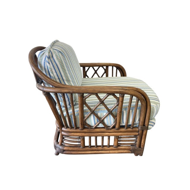 Elegant vintage rattan lounge chair inspired by the iconic Brighton Pavilion aesthetic, featuring a sculptural barrel...