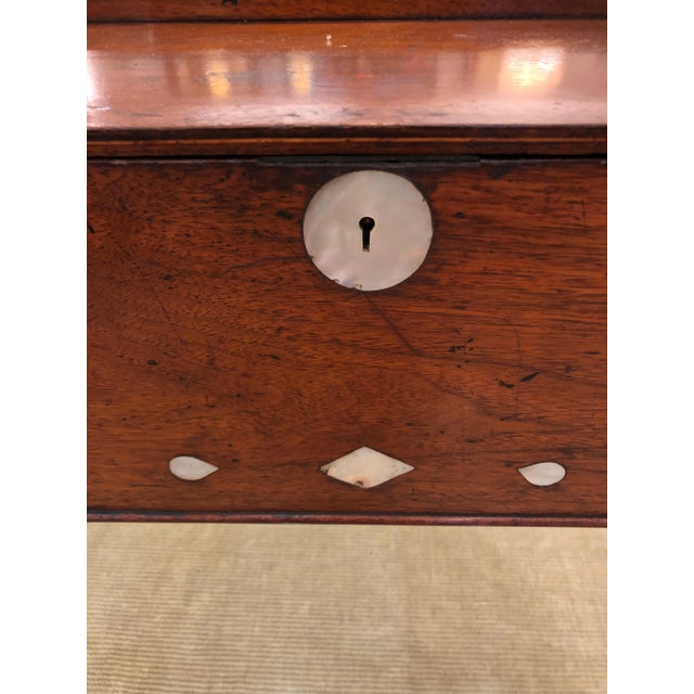 Impressive large box gorgeously hand crafted out of aged mahogany and mother of pearl decoration. There are crystal knobs...