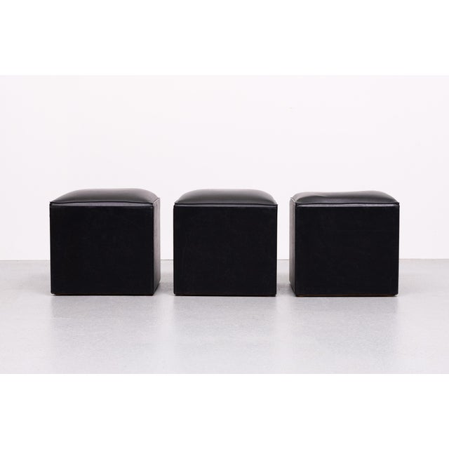 Very nice set of 3 identical small Stools or cube Ottomans . Black Faux Leather upholstery . Good condition . 1960s Link...