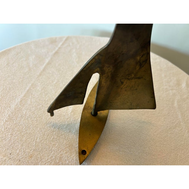 A beautiful brass addition to any shelf or table. Heavily weighted. Able to turn the sail to fit your needs.