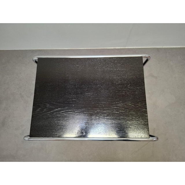 A refined Bauhaus side table attributed to Marcel Breuer, produced in Czechoslovakia. This modernist piece exemplifies...