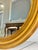 This is a gorgeous mid-20th century giltwood oval wall mirror in the French Louis Philippe style. The bright gold gilt...