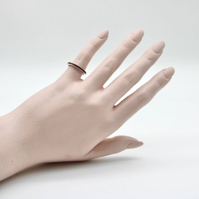 This is part of Chairish’s Fine Jewelry assortment. This 14k white gold ring contains square Table Cut rubies channel set...