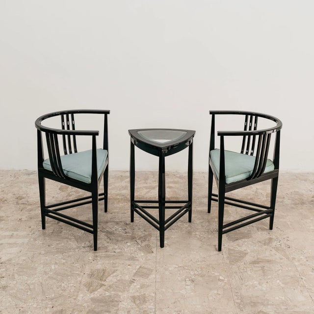 A stunning and exclusive vintage living room set dating back to the 1980s, consisting of a pair of tub chairs and a...