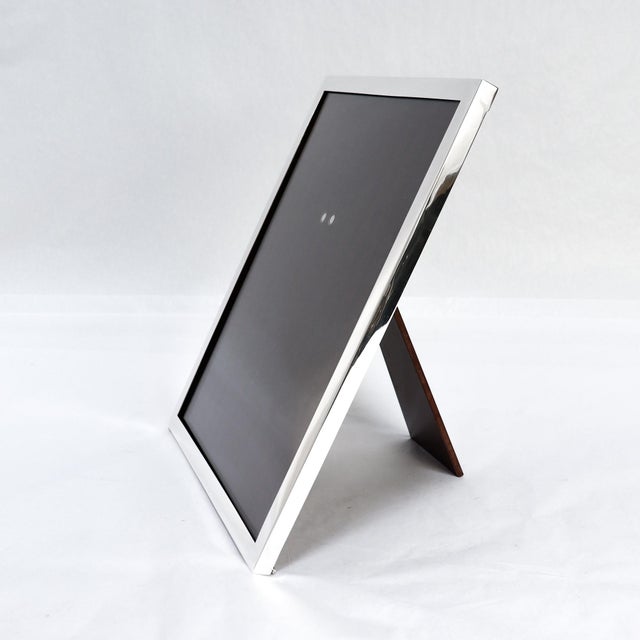 A fine vintage signed silver picture or photo frame. By Cartier. In sterling silver. With a robust easel back stand....