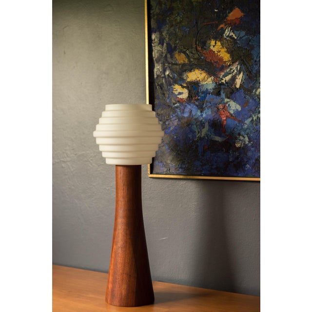 Mid century modern tall accent table lamp circa 1960's. Features a sculptural walnut base displaying natural warm wood...