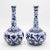 A fabulous vintage pair of European long neck bottle vases with hand painted floral designs in cobalt blue and white....