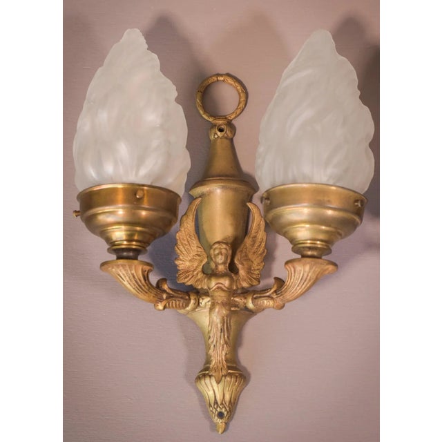 With iconic flambeau glass shades, this uniquely elegant pair of wall lamps is the epitome of baroque style. Decorated...
