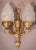 With iconic flambeau glass shades, this uniquely elegant pair of wall lamps is the epitome of baroque style. Decorated...