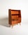 Teak frame with two open compartments, a pull-out desk, and a closed compartment with two doors and five drawers. Tapered...