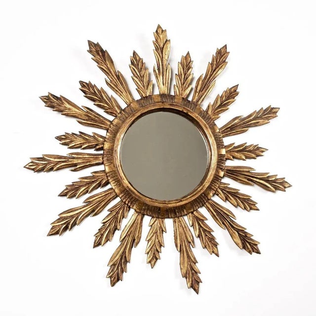Wonderful Mid-Century Modern gilded wood sunburst wall mirror. This amazing mirror was produced in France during 1950s....