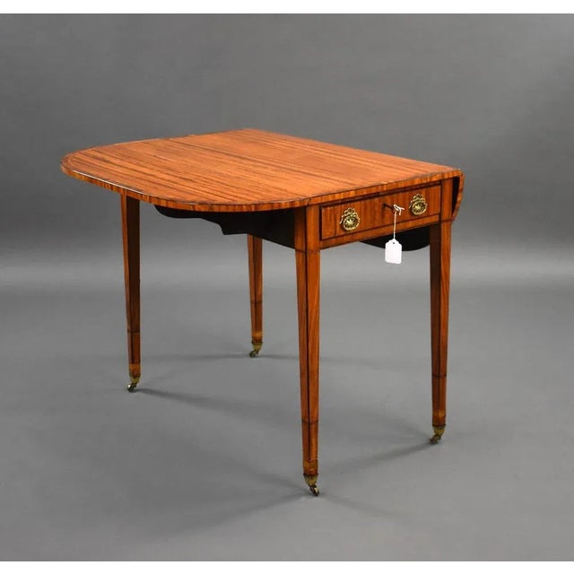 For sale is a good quality George III Satinwood pembroke table, having a well figured top with two drop leaves, the...