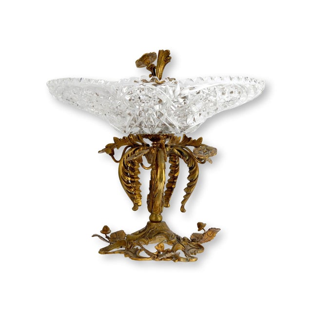 A striking French gilt bronze mounted cut crystal centerpiece with a richly cut bowl raised on an ornate base adorned with...