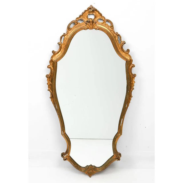 A nicely carved antique Italian mirror. The mirror is likely an early 20th century work (possibly late 19th C.) done in a...