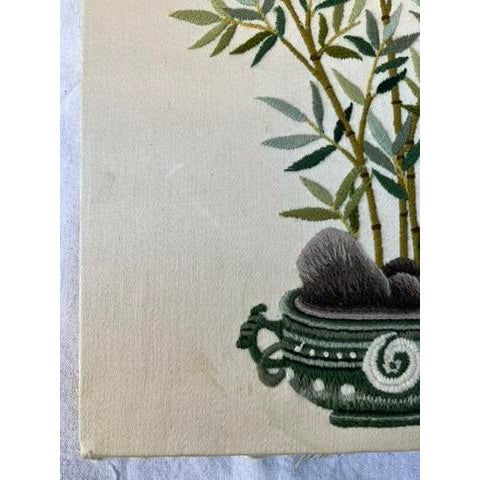 A single vintage hand embroidered cloth panel featuring an Asian style bamboo garden situated among rocks in a vessel....