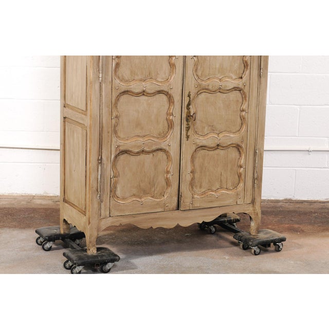 A French painted wood buffet deux-corps cabinet (armoire à deux corps), richly exhibiting handcrafted detail, from the...
