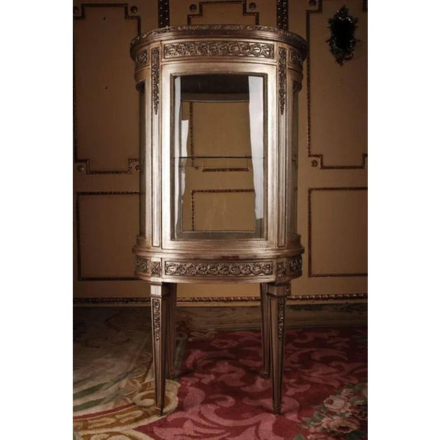 French salon vitrine in Louis XVI classicist style. Solid beechwood colored hand-painted. Oval one-drawered combered and...