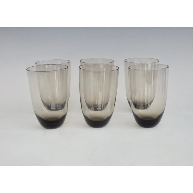Six cocktail glasses or water tumblers. Gently curving form in smoked glass.