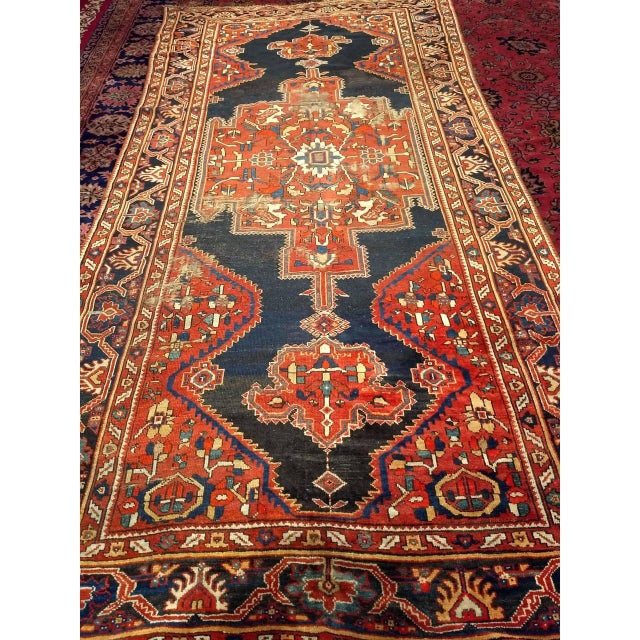 "Antique Persian Farahan gallery rug handwoven in Northwest Persia in the late 19th century features a striking central...