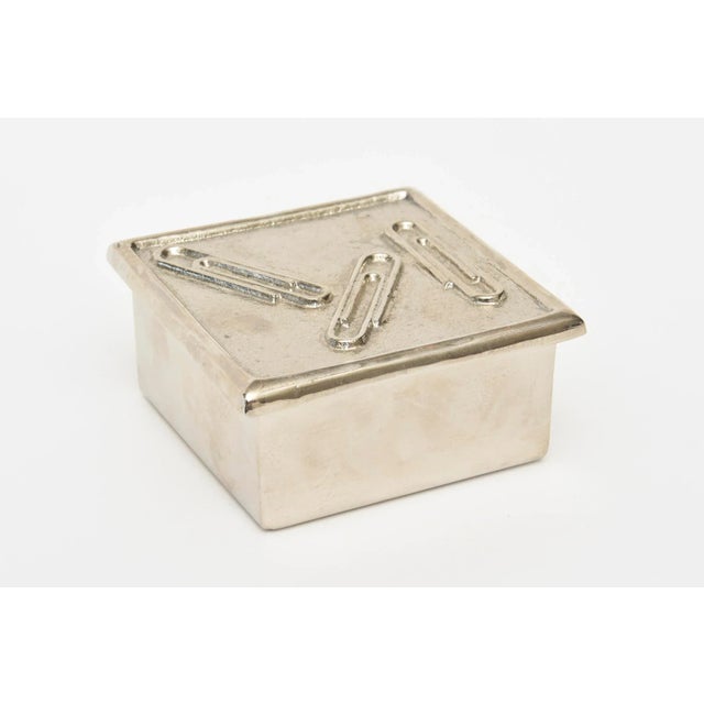 This vintage Sarreid small paperclip box has been nickeled silver over the brass and is from the 70's Great as a desk...
