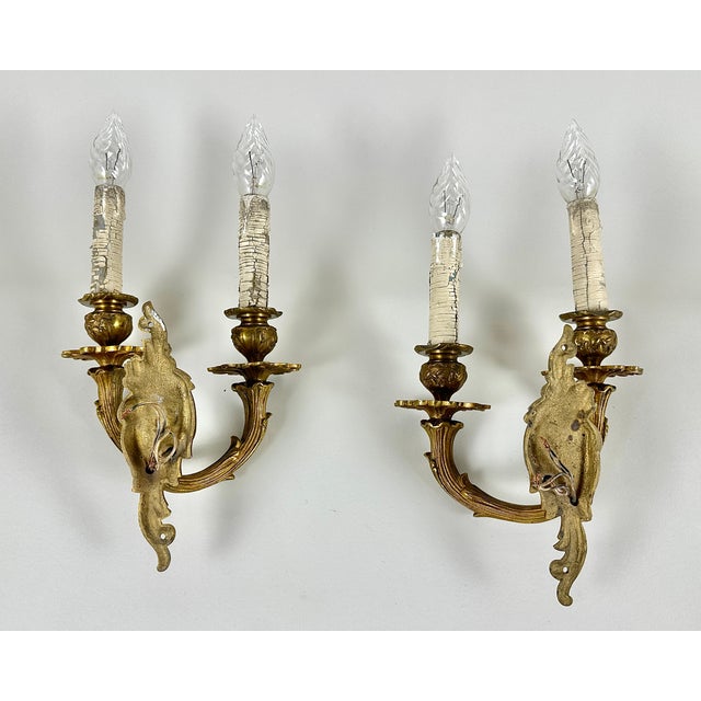 Elevate your interior with this exquisite pair of vintage bronze wall sconces, hailing from Belgium, circa 1960. These...