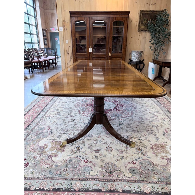 A distinguished Baker Stately Homes dining table that captures the refinement of Georgian design with a commanding...