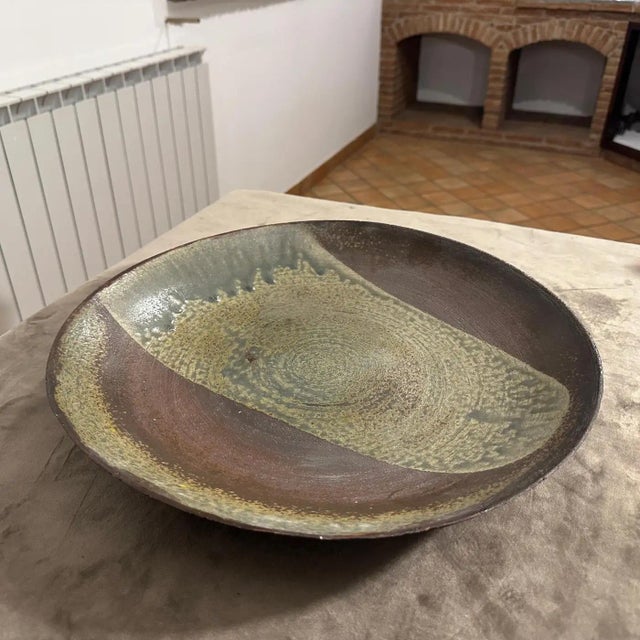 Refined centerpiece in porcelain stoneware, decorated in dark green and brown tones. Under the base, the manufacturer's...