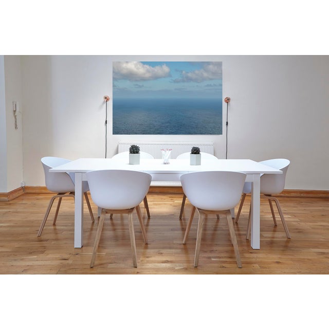 "Horizon Series". Each photo is divided into two halves, with the ocean in the upper half and the sky in the lower half....