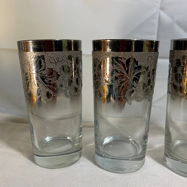 These are vintage mid-century modern highball tumblers featuring a silver fade and textured grape-vine motif, commonly...