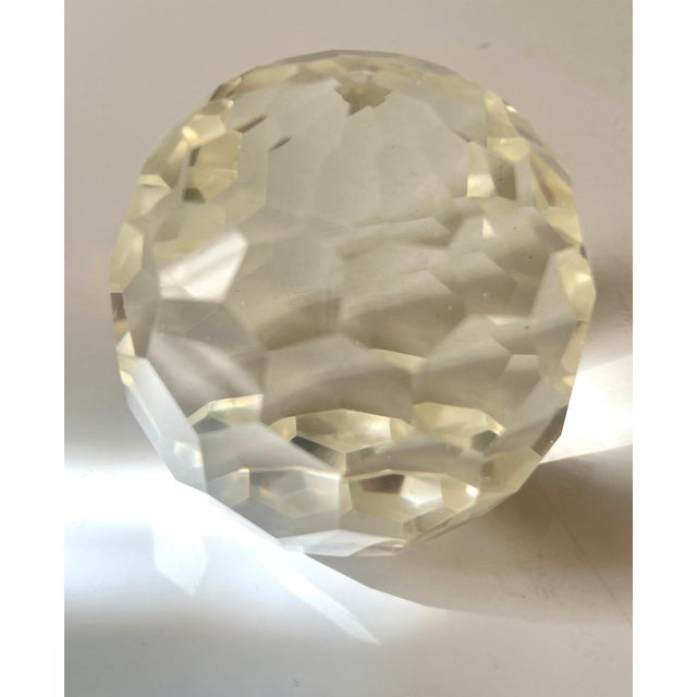 A 3 inch Crystal Paper weight with many facets. The piece is heavy and will hold down important papers, yet it's faceted...
