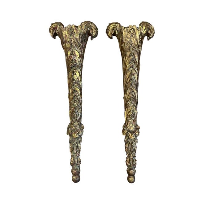 A stunning pair of large, gilt plaster wall pocket sconces. Each features a stylized acanthus leaf firm in cast plaster...