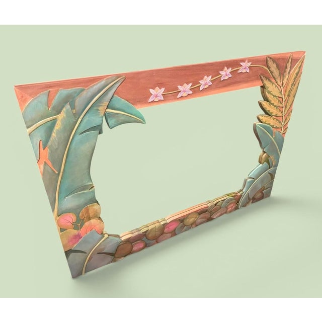 Large hand carved wall mirror featuring dimensional tropical botanical relief with layered leaf and floral motifs. Signed...