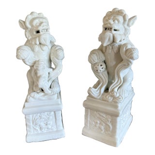 Blanc De Chine Foo Dogs With Ball and Baby, 1940’s, a Pair For Sale