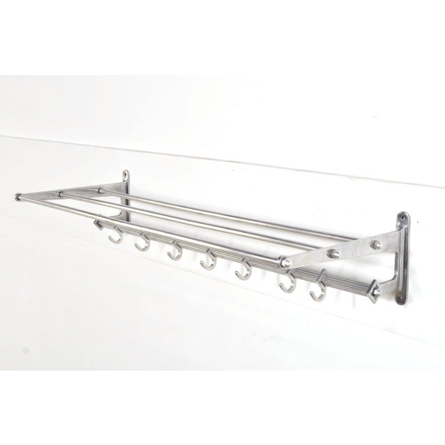 Beautiful aluminum vintage wall coat rack from the 1970s in art deco style with 7 sliding hooks. The coat rack has been...