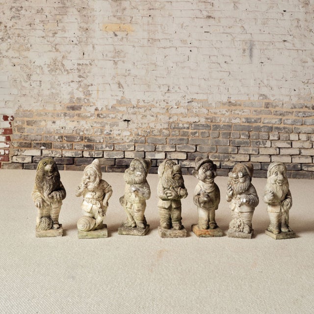 Add whimsical charm and historic character to your space with this set of seven 19th century French stone Seven Dwarfs...