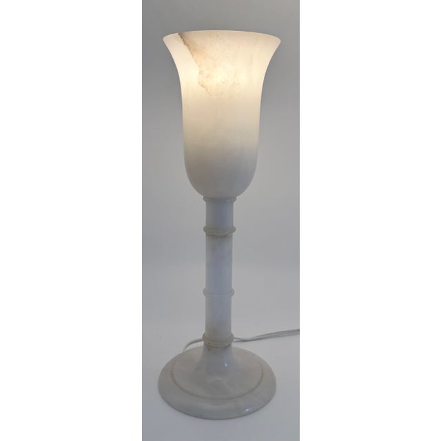 An early 20th century neoclassical alabaster urn lamp. Mostly white with one grey vein, this lamp emits a soft and subtle...