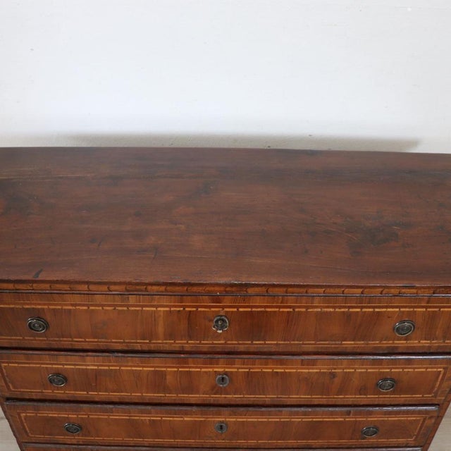 We present this elegant antique Italian chest of drawers dating back to the first half of the 18th century. A piece of...