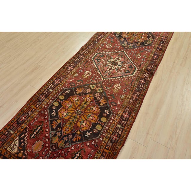 An authentic semi-antique tribal Sarab runner hand-knotted with fine wool and natural dyes. This nomadic oriental rug...