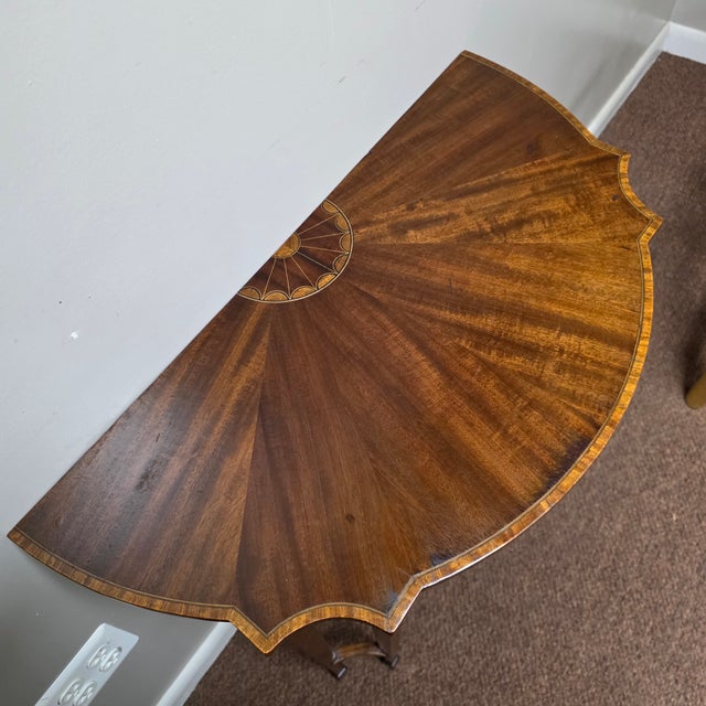 Elegant American Federal demi-lune pier table, circa 1800, crafted in richly figured mahogany and distinguished by an...