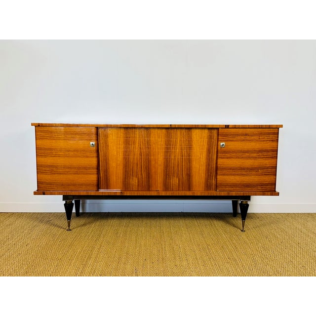 Magnificent buffet, sideboard in the late Art Deco modernist style, created in the 1950s. This slender piece perfectly...