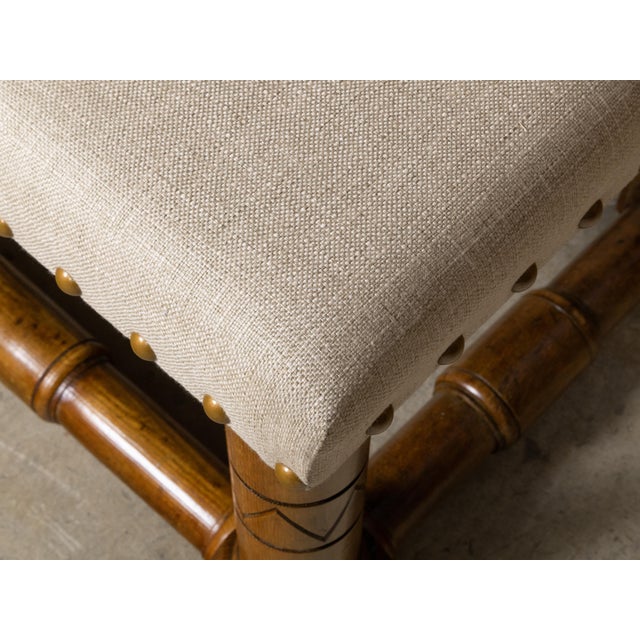 An English rustic stool from circa 1900 with cylindrical legs, incised accents, square block joints and side stretchers....