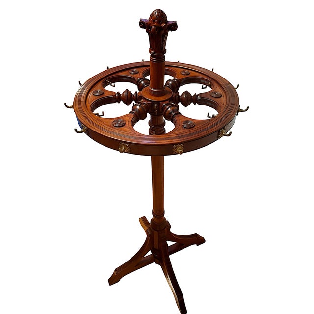 This piece is an exceptionally rare and distinctive antique commercial clothing carousel (commonly referred to as a...
