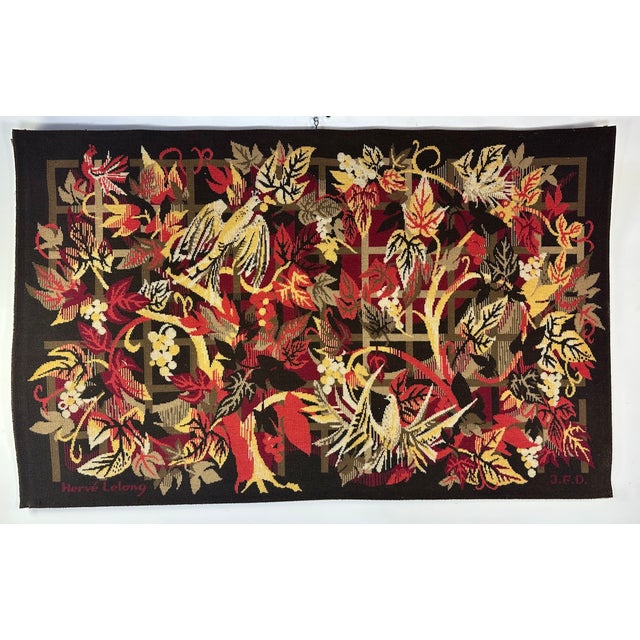 Large wall tapestry signed Hervé Lelong, made around 1960 in woven wool. This decorative work features a lush composition...