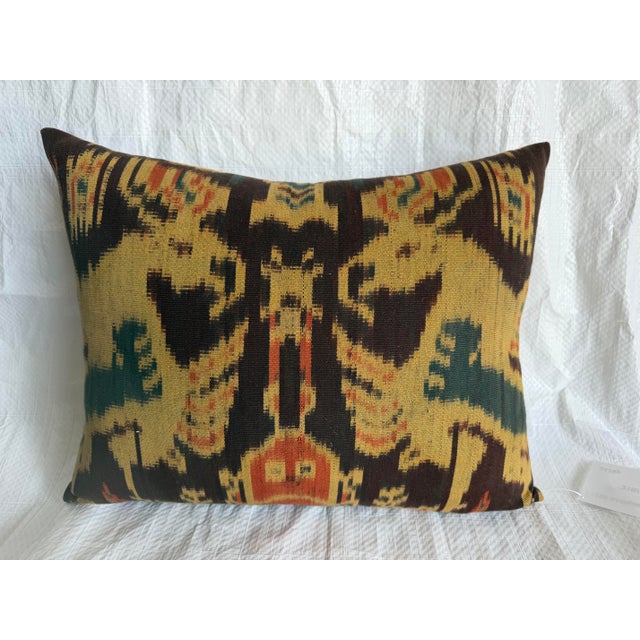 beautifully preserved Uzbek silk ikat pillow fashioned from a rare 19th century textile fragment. The design showcases a...