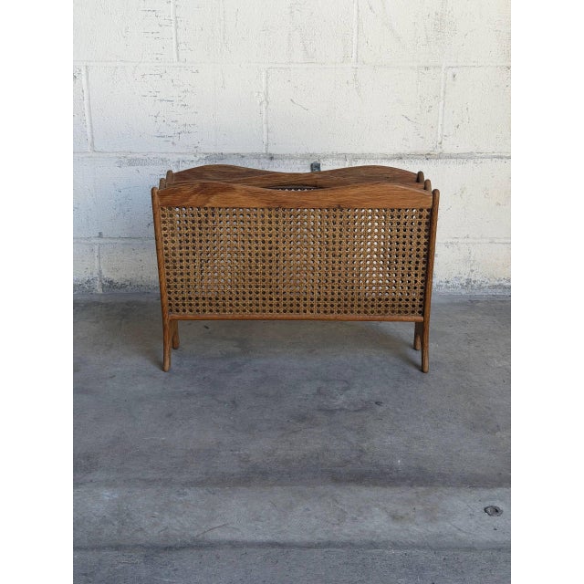 Beautiful vintage Danish modern magazine rack crafted in oak with woven cane panels and elegant sculptural lines...